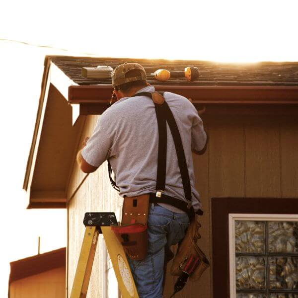 Sydney Gutter Guys technician repairing guttering on a single-storey home in Western Sydney Sydney Gutter Guys technician repairing guttering on a single-storey home in Western Sydney