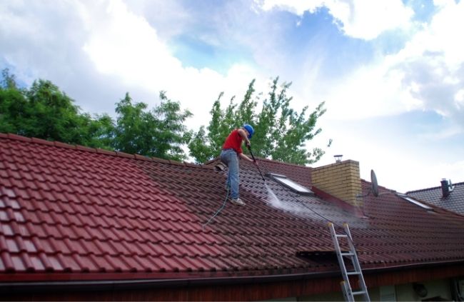 Roof cleaner using high-pressure washing to remove dirt and moss during roof cleaning by Sydney Gutter Guys Roof cleaner using high-pressure washing to remove dirt and moss during roof cleaning by Sydney Gutter Guys