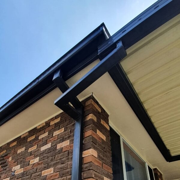 Professional downpipe replacement in Western Sydney by Sydney Gutter Guys installing new metal downpipe.